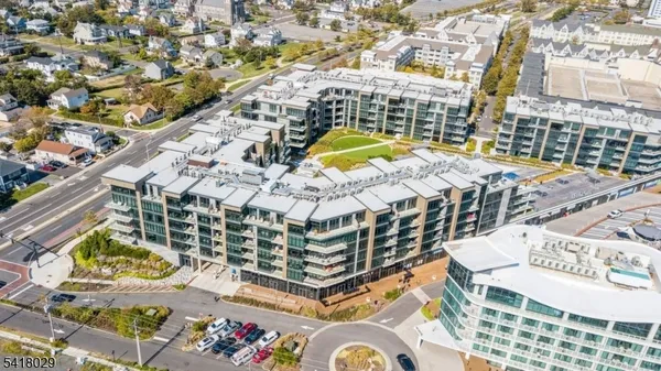 a building with swimming pool and lawn chairs