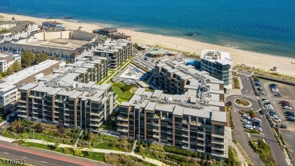 an aerial view of a residential apartment building with a yard