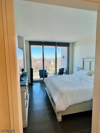 a bedroom with a large bed and a large window