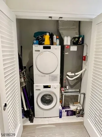 a utility room with sink dryer and washer
