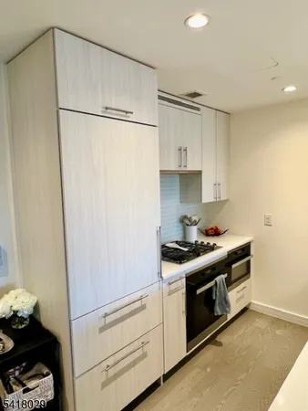 a kitchen with white cabinets and white appliances