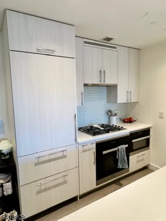 a stove top oven sitting inside of a kitchen