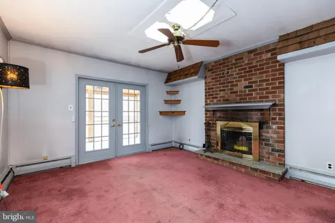 a view of empty room with a fireplace