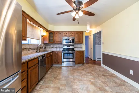 a kitchen with stainless steel appliances granite countertop a stove cabinets and a refrigerator