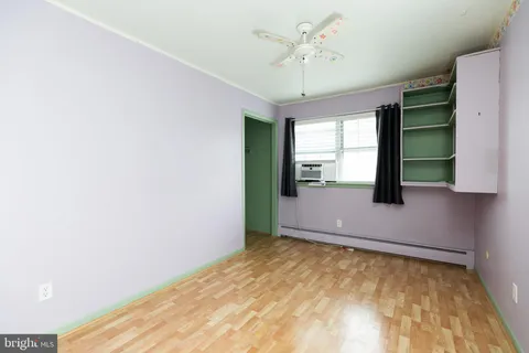 a view of room with hardwood floor and ceiling fan