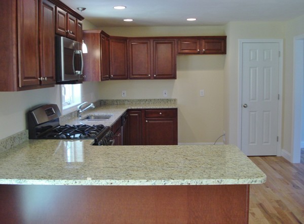 80 Chadwick Road Haverhill, MA 01835 - Photo 2 of 15 a kitchen with stainless steel appliances granite countertop a sink refrigerator and stove