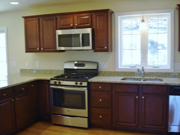 80 Chadwick Road Haverhill, MA 01835 - Photo 4 of 15 a kitchen with granite countertop a stove and a microwave