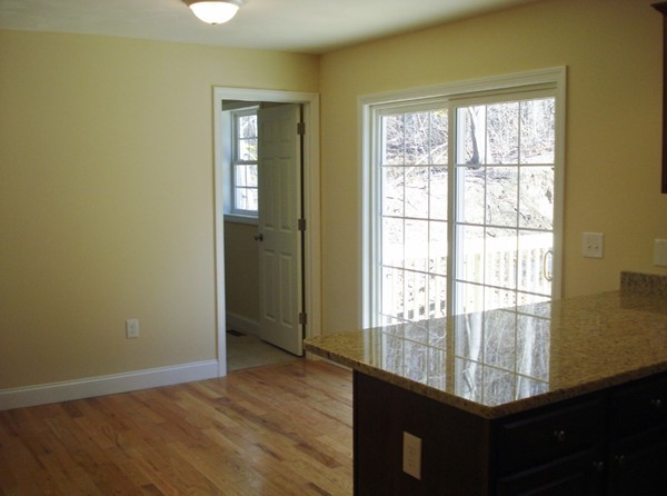 80 Chadwick Road Haverhill, MA 01835 - Photo 5 of 15 a view of an empty room with wooden floor and a window