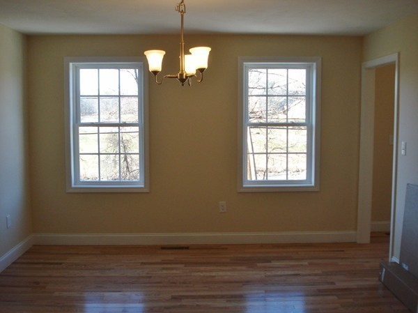 80 Chadwick Road Haverhill, MA 01835 - Photo 7 of 15 a view of an empty room with wooden floor and a window