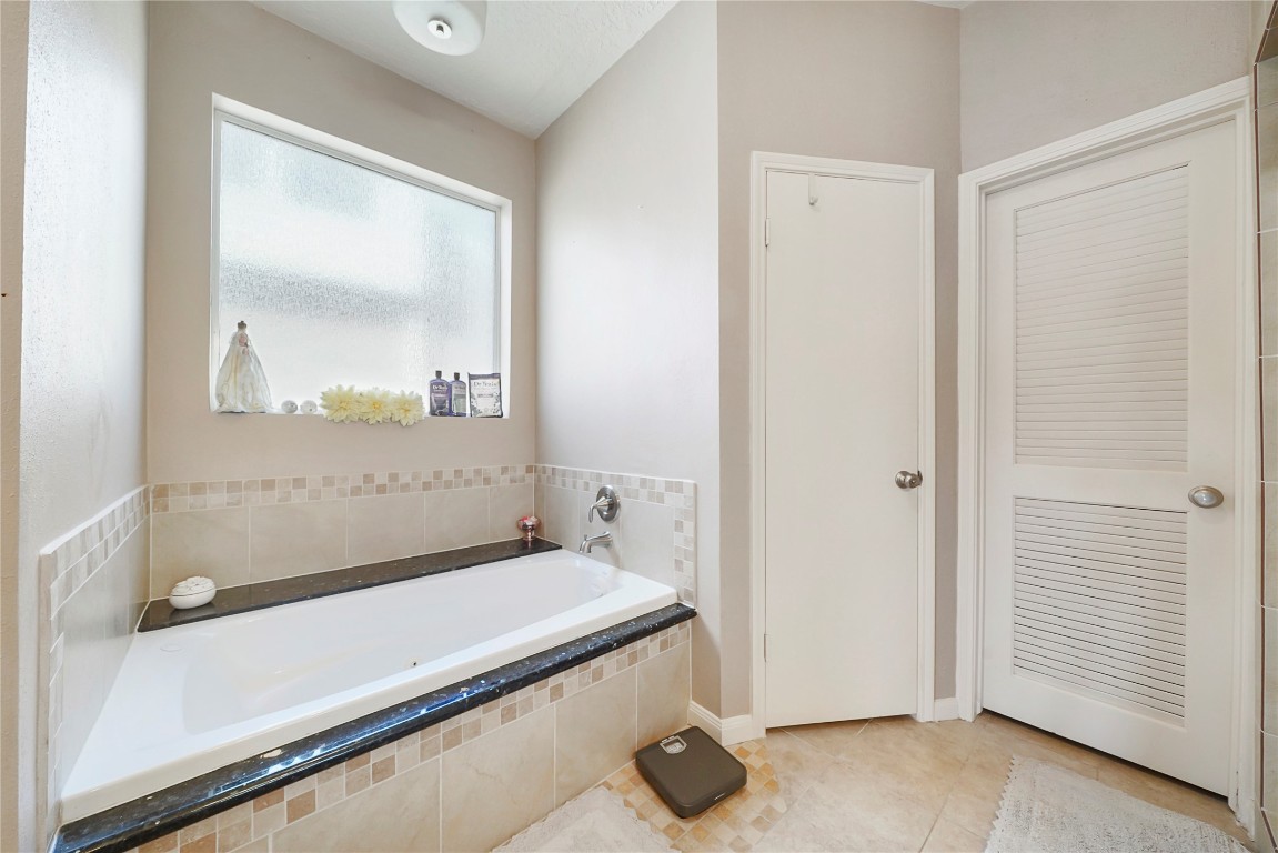 14607 Muirfield Lane Houston, TX 77095 - Photo 13 of 33 a view of a bathroom with a sink and a mirror