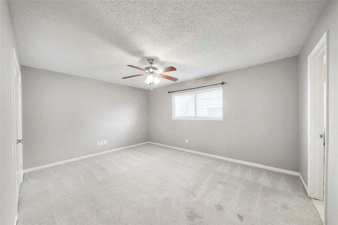 14607 Muirfield Lane Houston, TX 77095 - Photo 16 of 33 a view of an empty room with a chandelier fan