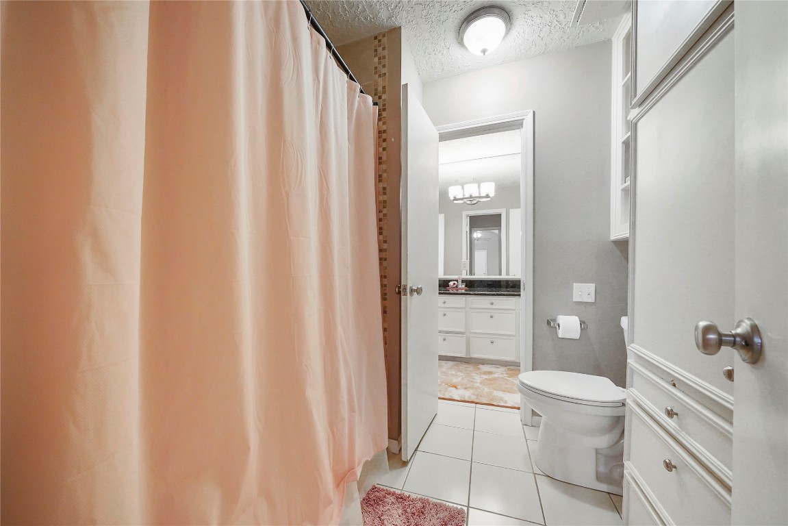 14607 Muirfield Lane Houston, TX 77095 - Photo 18 of 33 a bathroom with a granite countertop sink toilet and shower