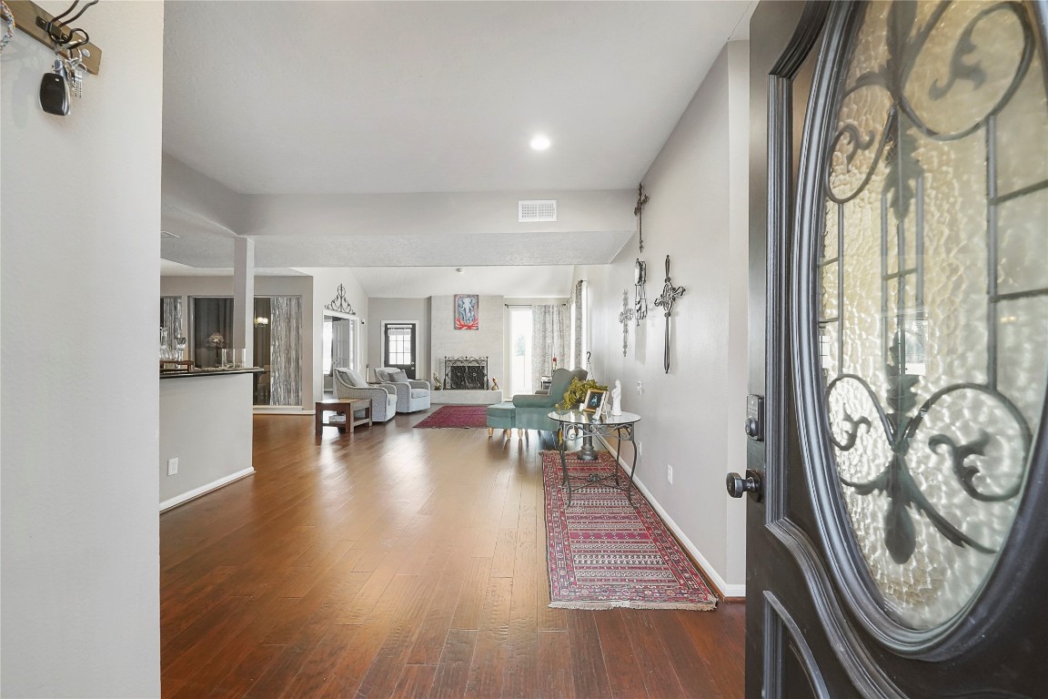 14607 Muirfield Lane Houston, TX 77095 - Photo 21 of 33 wooden floor with a water heater on the kitchen