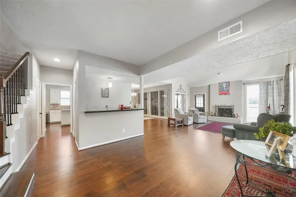 a view of living room filled with furniture and wooden floor
