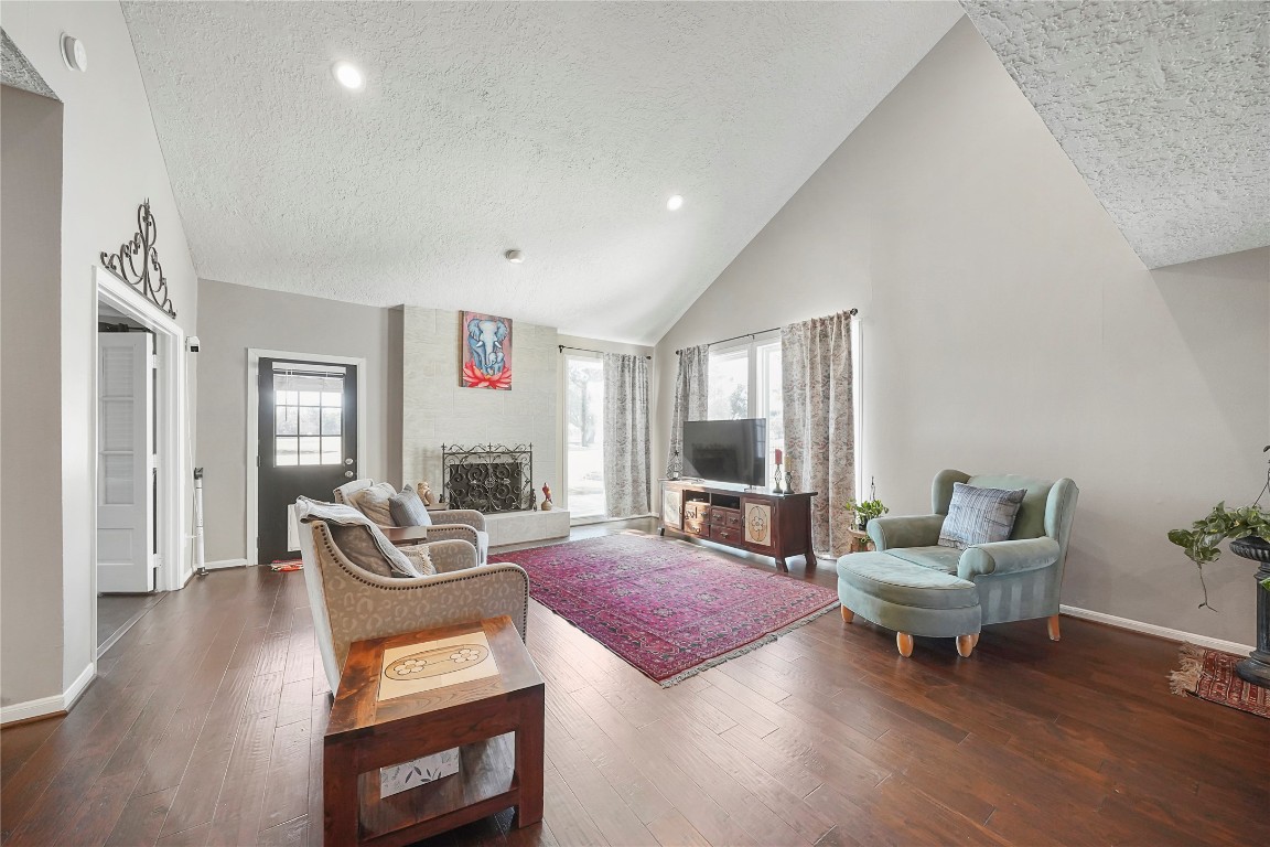 14607 Muirfield Lane Houston, TX 77095 - Photo 23 of 33 a living room with furniture and a wooden floor