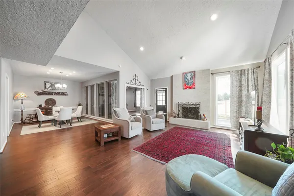 a living room with furniture window and wooden floor