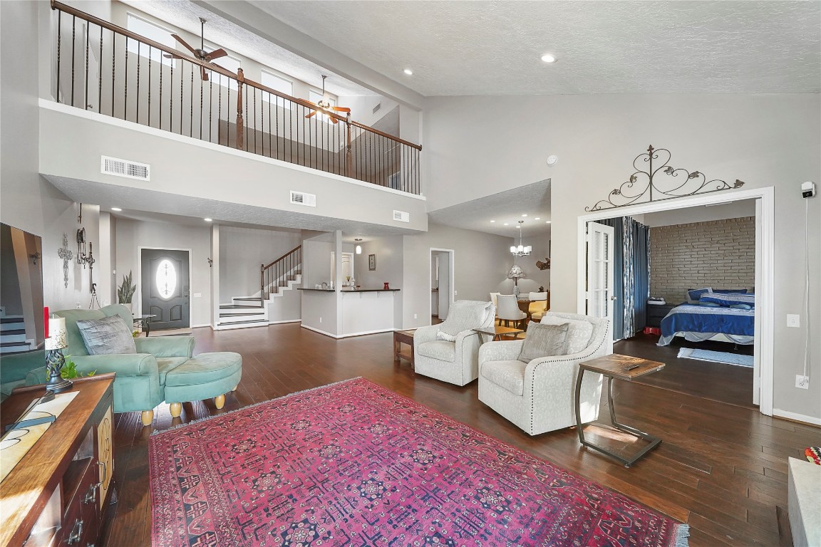 14607 Muirfield Lane Houston, TX 77095 - Photo 25 of 33 a living room with furniture a rug and a chandelier