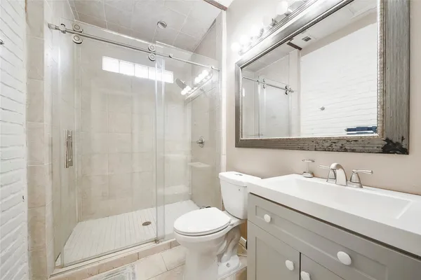 a bathroom with a sink toilet and shower