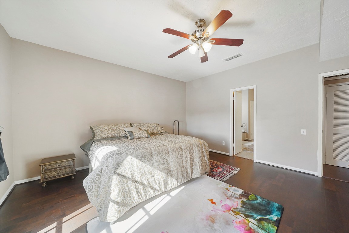 14607 Muirfield Lane Houston, TX 77095 - Photo 33 of 33 a bedroom with a bed and a chandelier