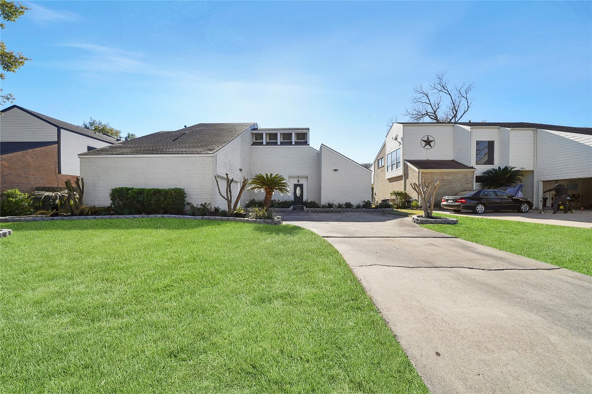 14607 Muirfield Lane Houston, TX 77095 - Photo 4 of 33 a front view of a house with a yard and garage