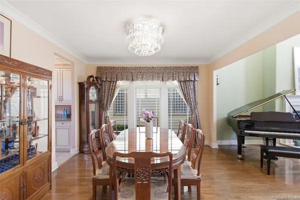 a kitchen with kitchen island granite countertop a table chairs microwave and cabinets