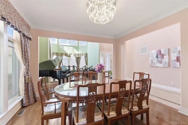 a living room with furniture a flat screen tv and a dining table