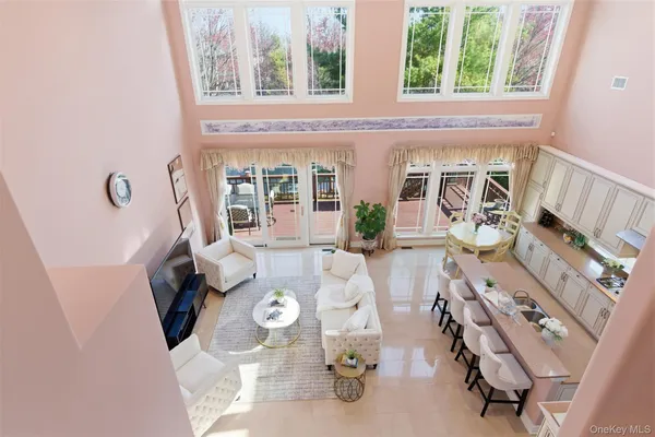 a living room with furniture kitchen view and a table