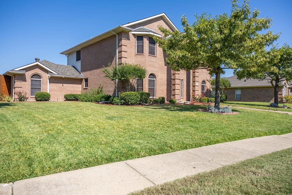 4113 Bluffpoint Road Rowlett, TX 75088 - Photo 4 of 39 a front view of a house with a yard and trees