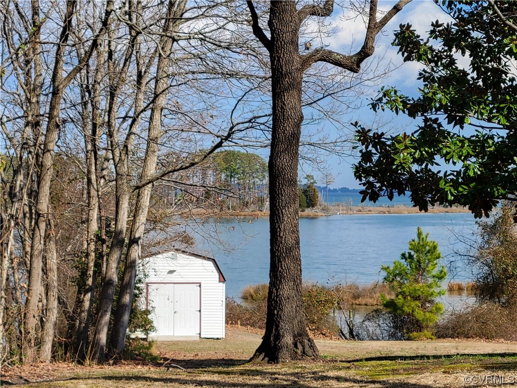 405 Locklies Creek Road Topping, VA 23169 - Photo 18 of 30 a front view of a house with garden