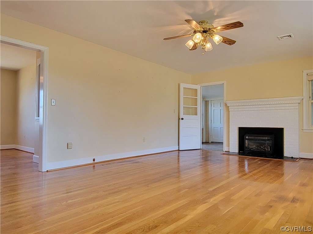 405 Locklies Creek Road Topping, VA 23169 - Photo 19 of 30 an empty room with windows and a fireplace