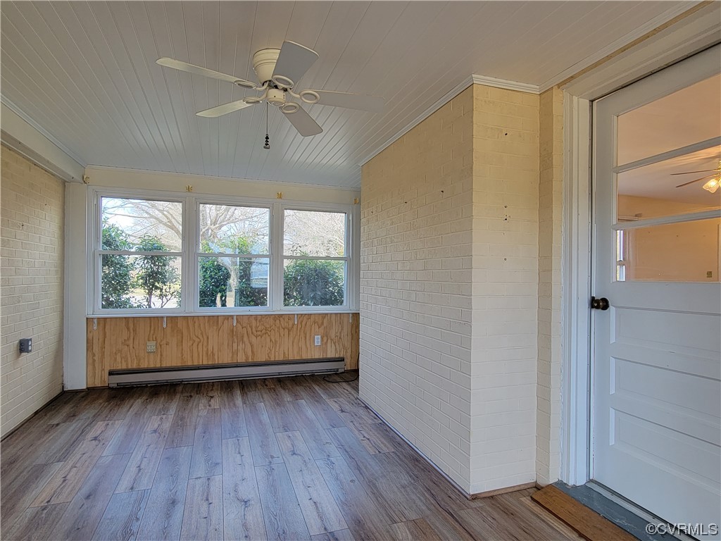405 Locklies Creek Road Topping, VA 23169 - Photo 21 of 30 an empty room with wooden floor and windows