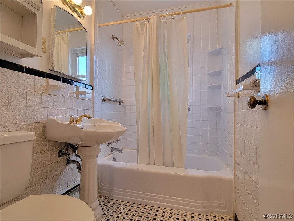 405 Locklies Creek Road Topping, VA 23169 - Photo 23 of 30 a bathroom with a sink a toilet and shower