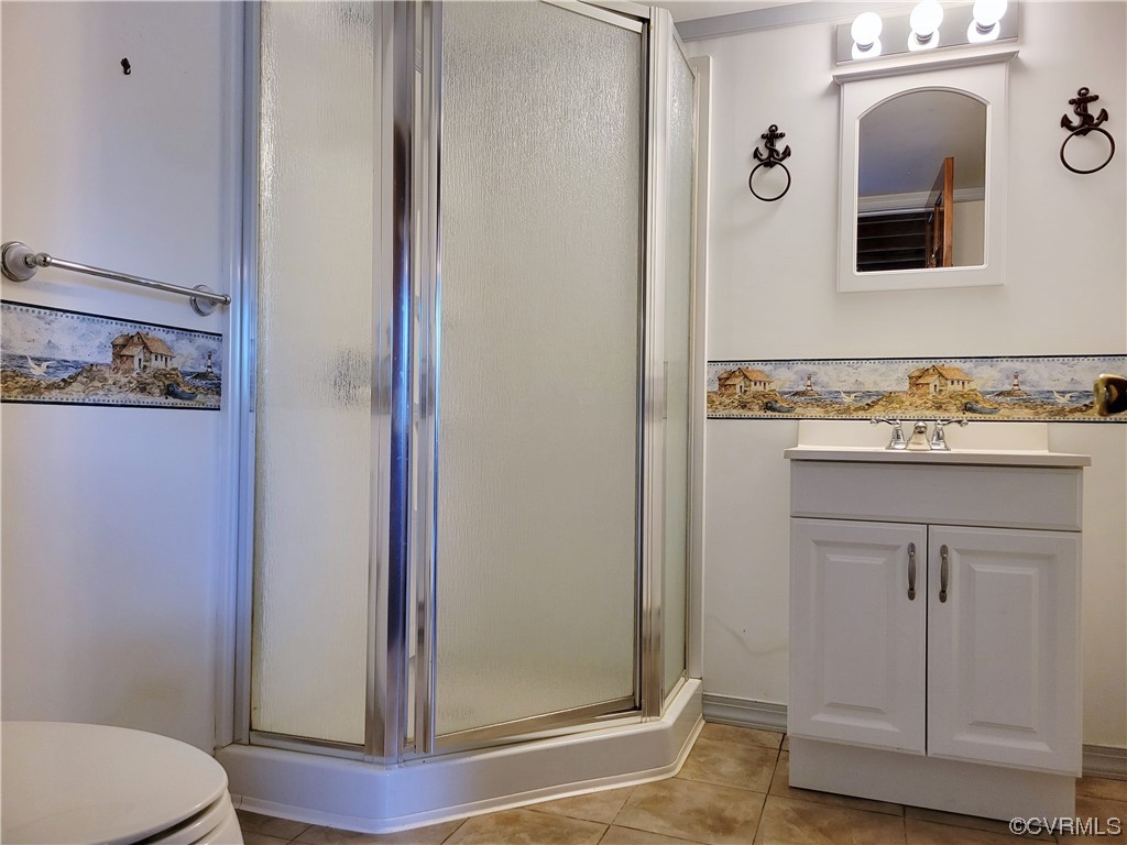 405 Locklies Creek Road Topping, VA 23169 - Photo 29 of 30 a bathroom with a sink and a mirror