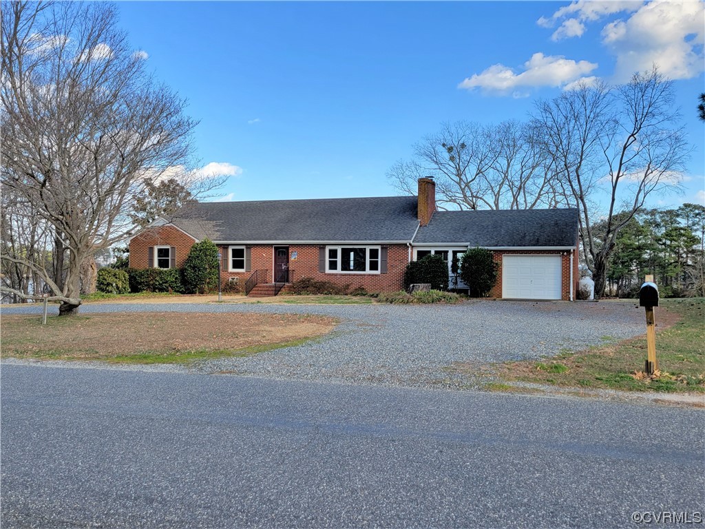 405 Locklies Creek Road Topping, VA 23169 - Photo 4 of 30 a front view of a house with a yard and garage