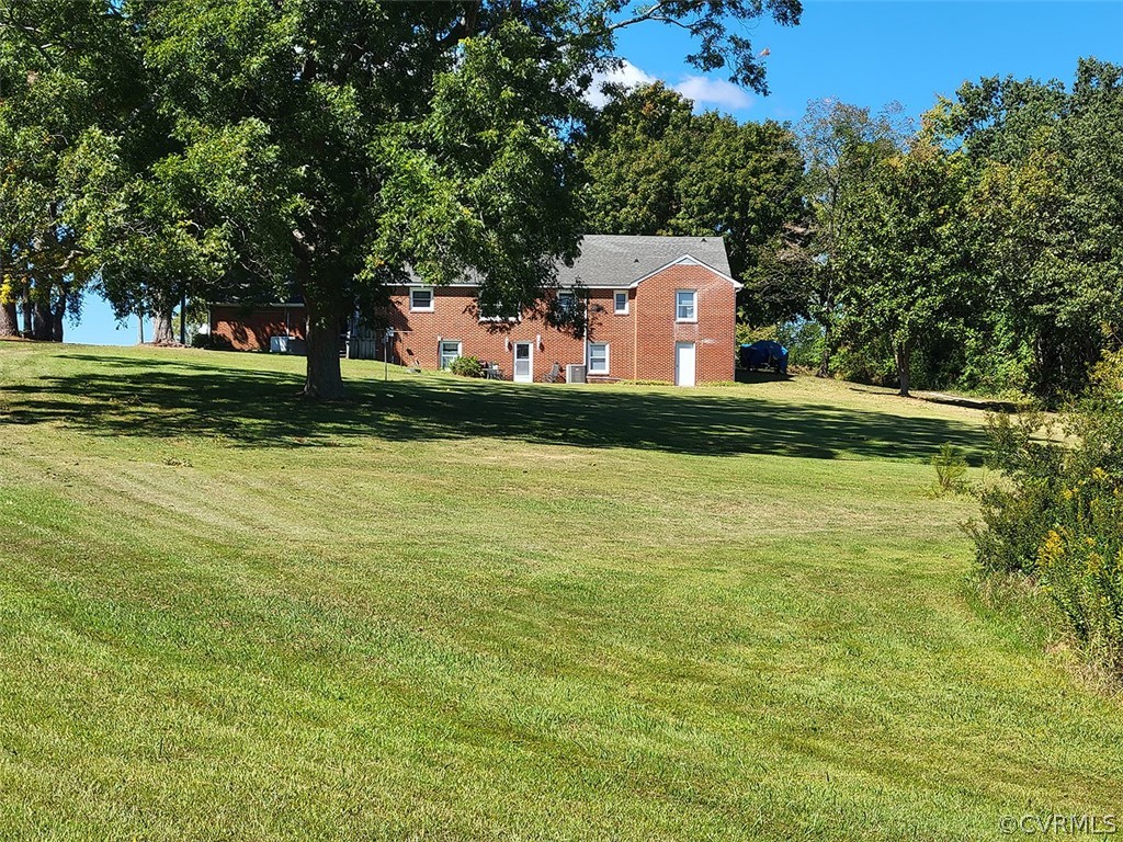 405 Locklies Creek Road Topping, VA 23169 - Photo 7 of 30 a front view of a house with garden