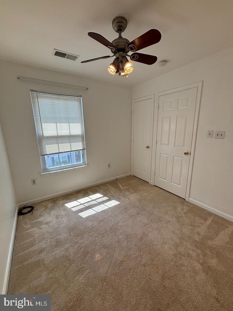 22985 Fleet Terrace Sterling, VA 20166 - Photo 12 of 14 an empty room with windows and fan