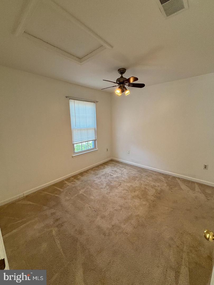 22985 Fleet Terrace Sterling, VA 20166 - Photo 13 of 14 an empty room with a ceiling fan and window