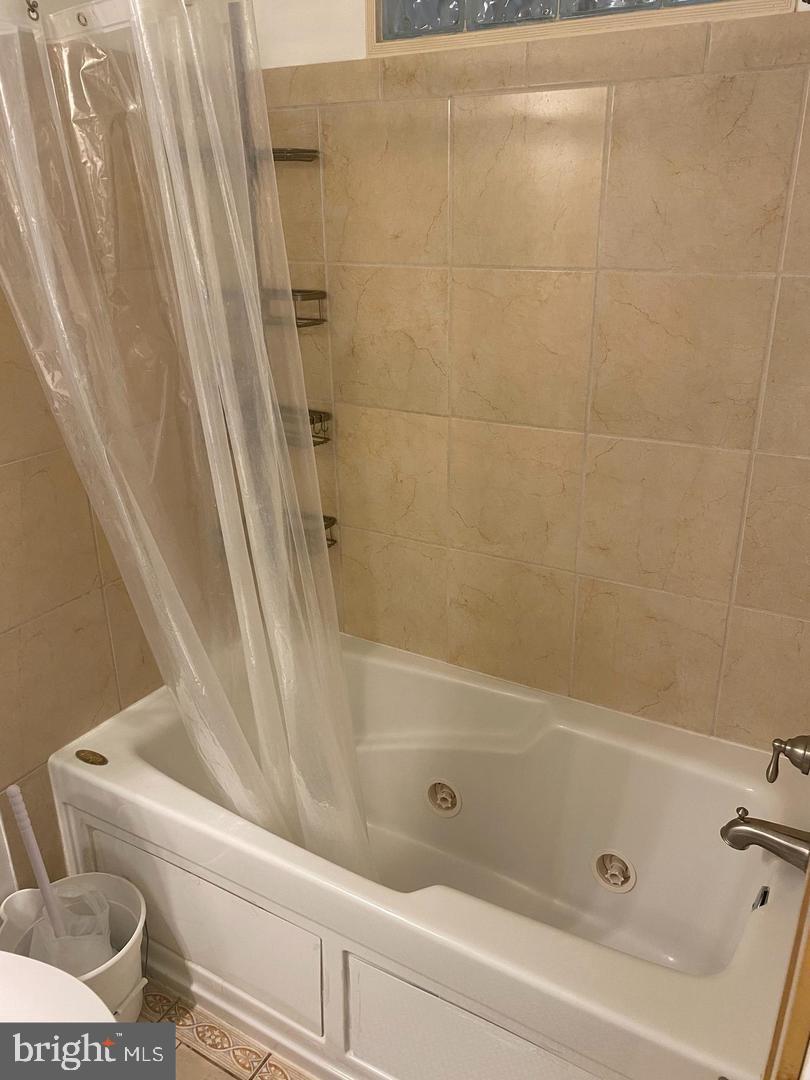 22985 Fleet Terrace Sterling, VA 20166 - Photo 7 of 14 a bathroom with a shower and a toilet