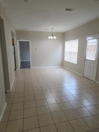 a view of a livingroom with an empty space and window
