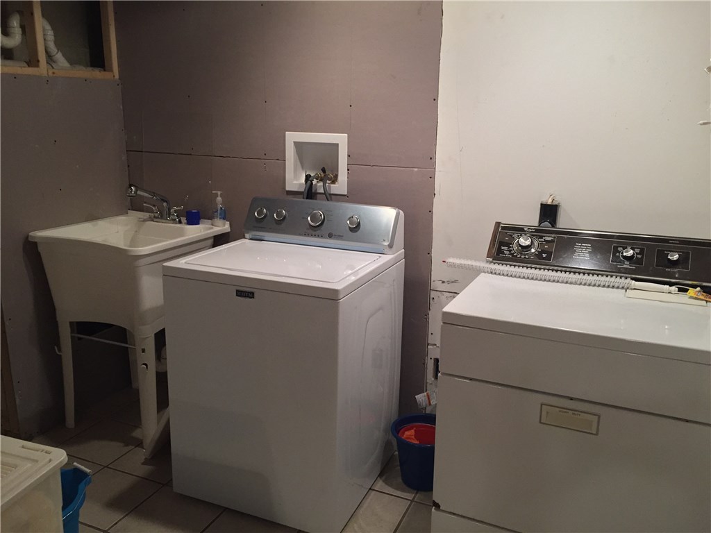 90 Progress Street Lincoln, RI 02865 - Photo 24 of 31 The Lower Level Is Sudo Finished With Tile Flooring And Sheet Rock. Washer, Dryer And Utility Sink Will Convey With The Sale.