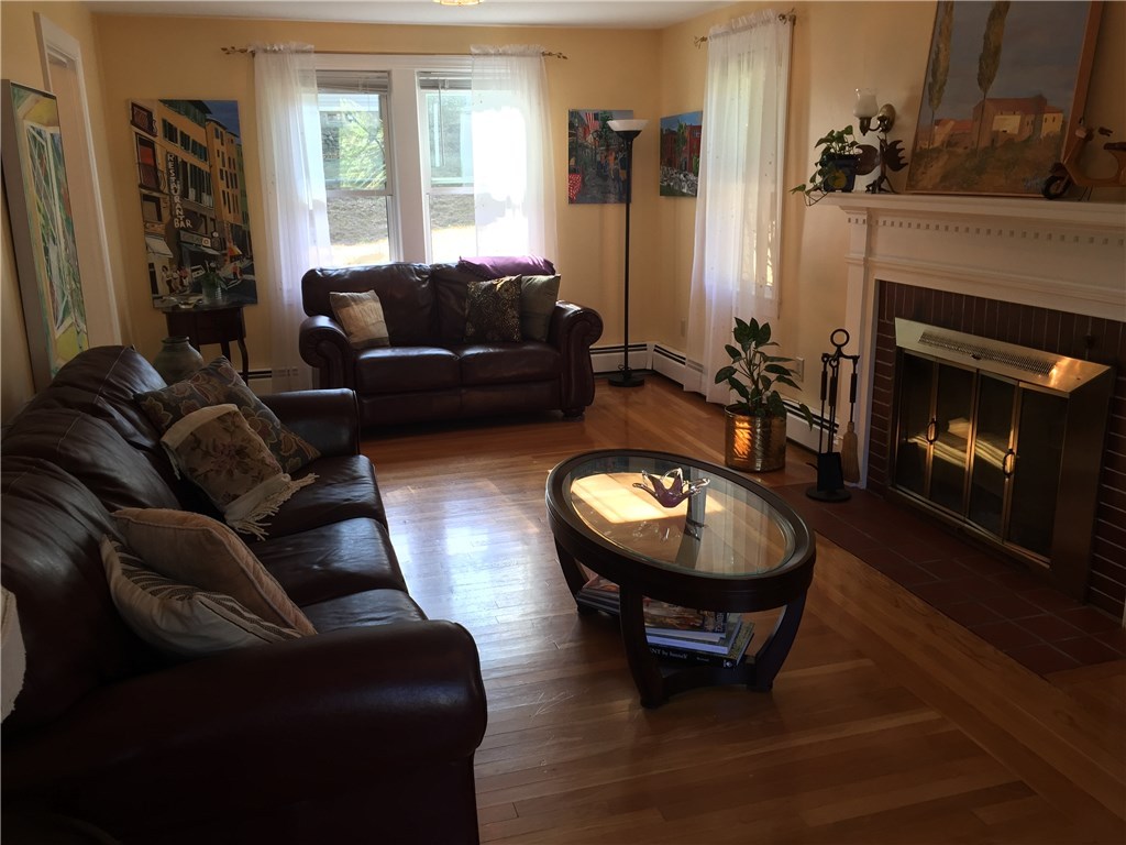 90 Progress Street Lincoln, RI 02865 - Photo 4 of 31 A Wood Burning, Brick Fireplace With Custom, Dental Woodworking Is A Centerpiece In This Oversized Living Room.