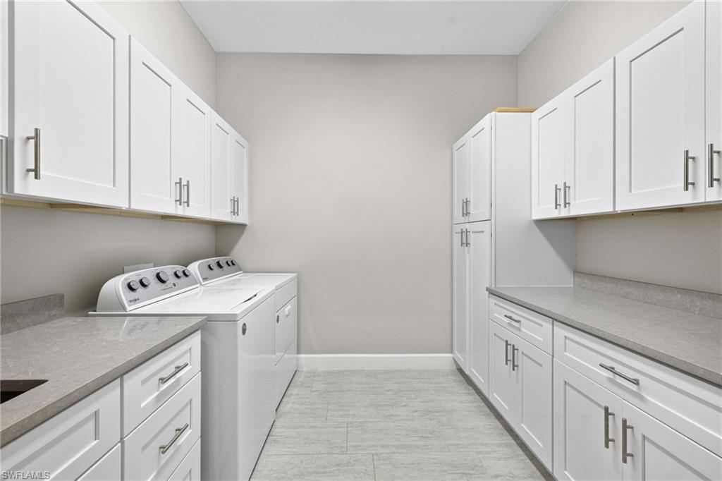 20734 Corkscrew Shores Boulevard Estero, FL 33928 - Photo 30 of 50 a utility room with cabinets washer and dryer