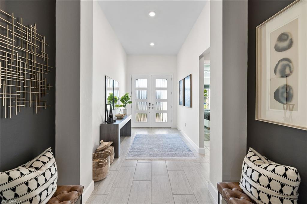 20734 Corkscrew Shores Boulevard Estero, FL 33928 - Photo 3 of 50 a view of a hallway with wooden floor and a living room