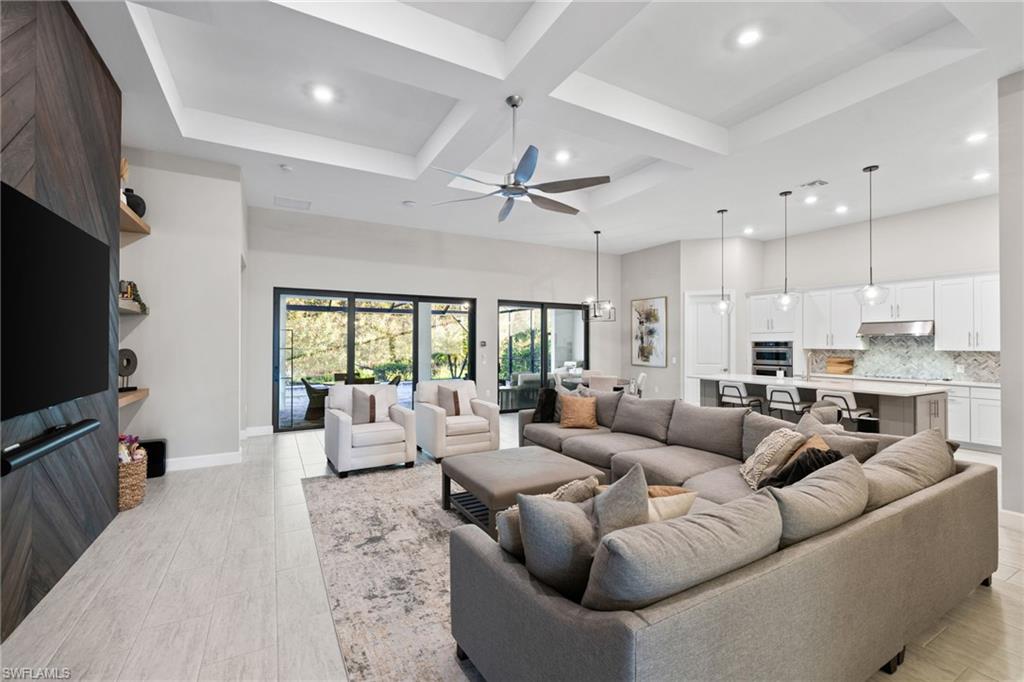 20734 Corkscrew Shores Boulevard Estero, FL 33928 - Photo 33 of 50 a living room with furniture a ceiling fan and a flat screen tv