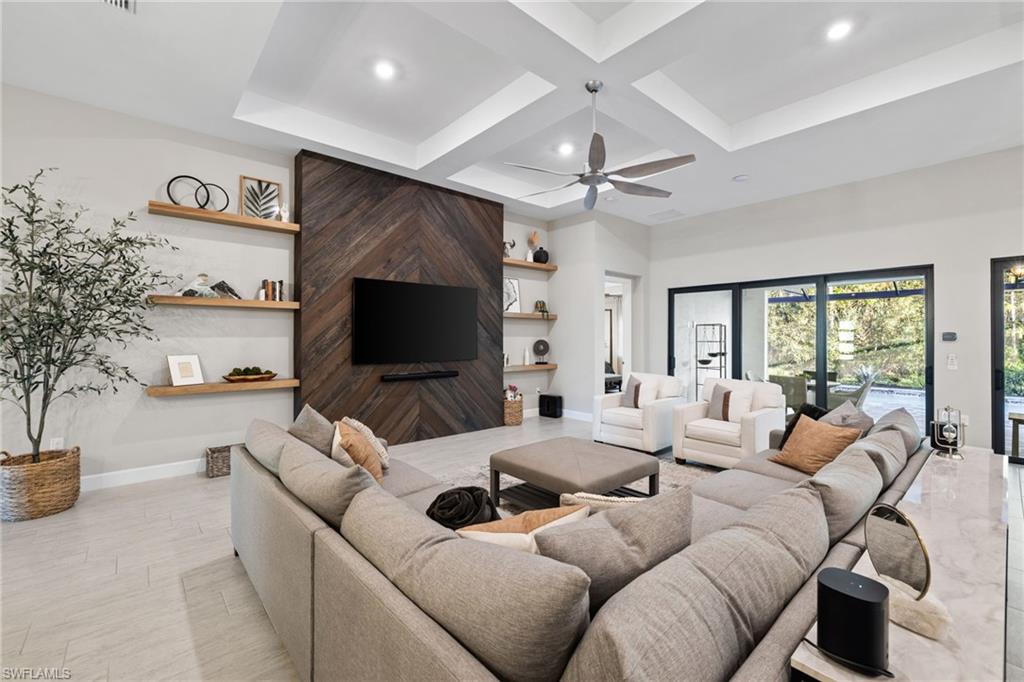 20734 Corkscrew Shores Boulevard Estero, FL 33928 - Photo 5 of 50 a living room with furniture a flat screen tv and a large window