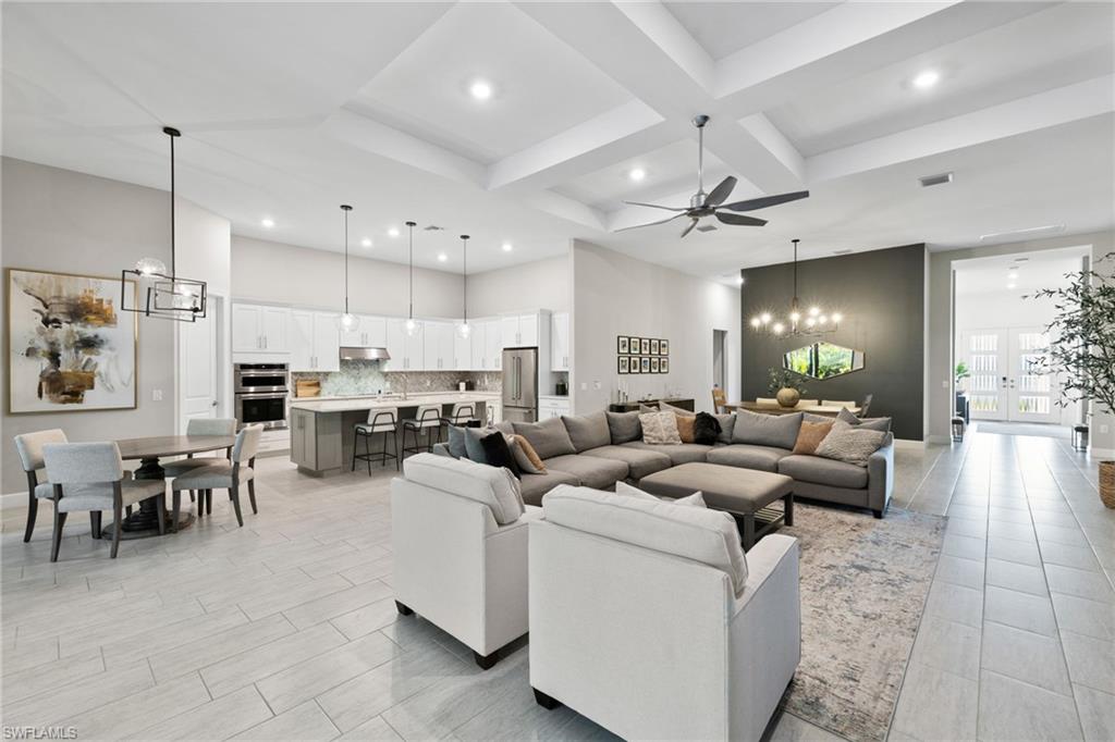 20734 Corkscrew Shores Boulevard Estero, FL 33928 - Photo 7 of 50 a living room with furniture kitchen view and a chandelier
