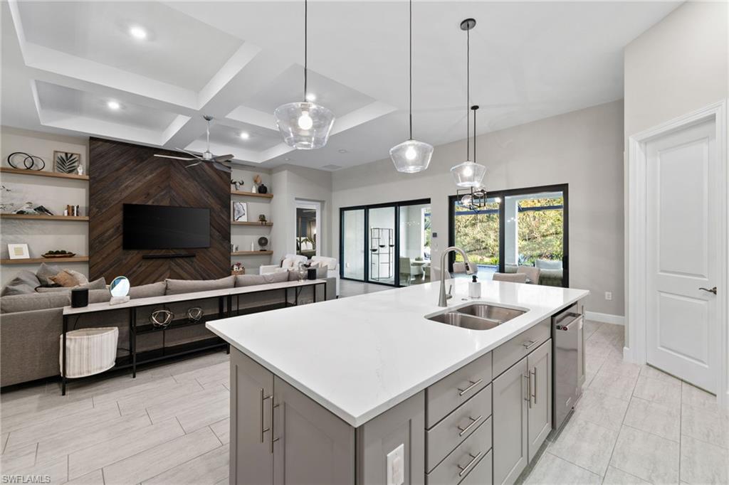 20734 Corkscrew Shores Boulevard Estero, FL 33928 - Photo 9 of 50 a kitchen with a stove a counter top space and living room view