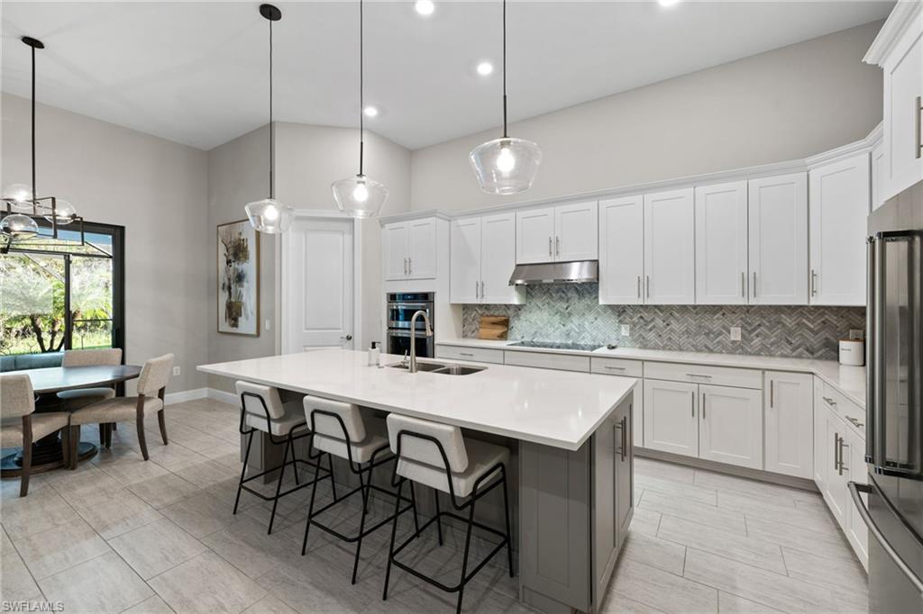 20734 Corkscrew Shores Boulevard Estero, FL 33928 - Photo 10 of 50 a kitchen with a table and chairs in it