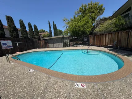 a view of a swimming pool with wooden deck
