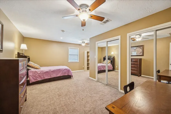 a living room with furniture and a dresser